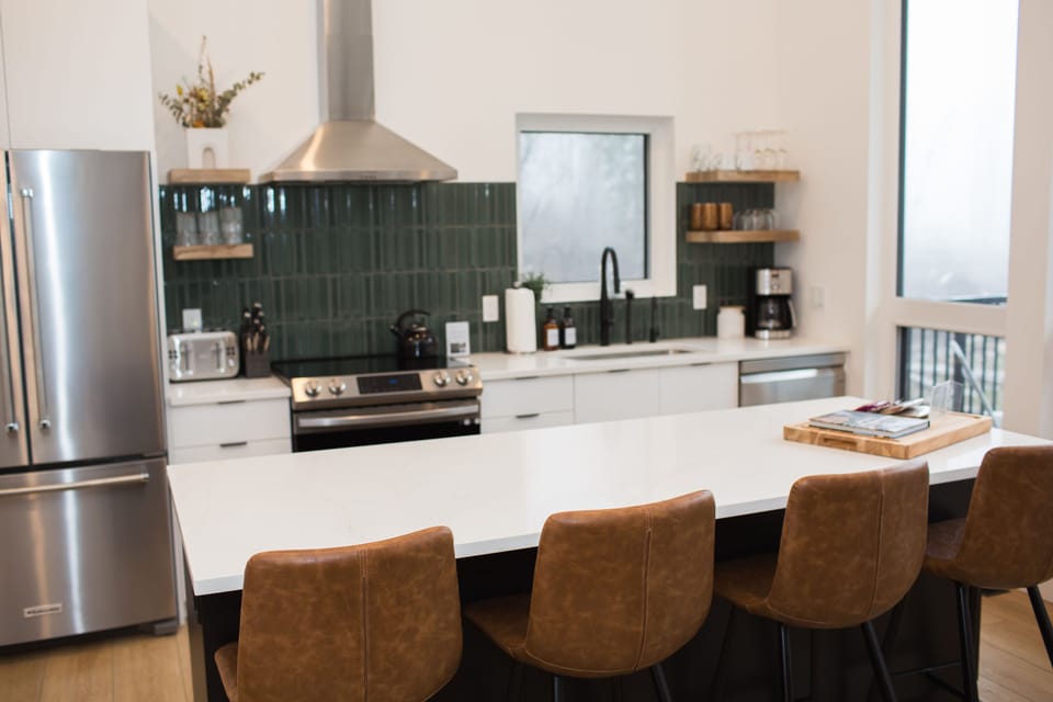 Modern kitchen with all the amenities to make you feel at home. Well stocked and labelled .