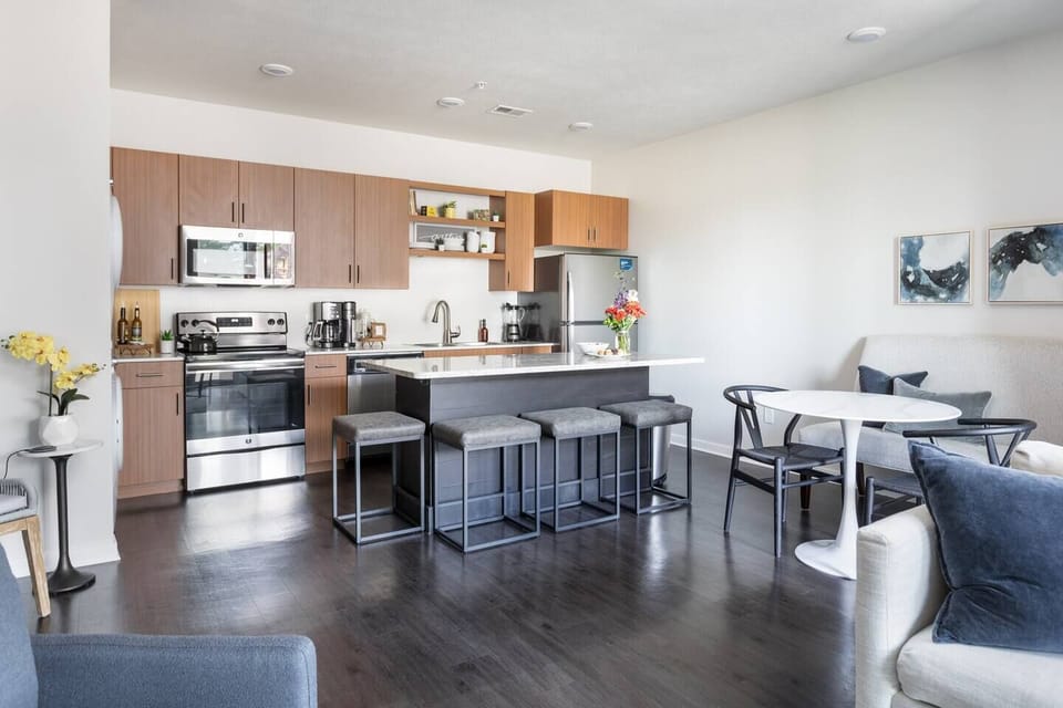 Gather around the spacious island to share laughter, a glass of wine, and a delicious charcuterie board—perfect for a cozy night in or as a prelude to an evening out on the town.