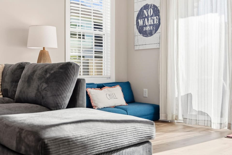 Sunlit living room with cozy seating and airy vibes