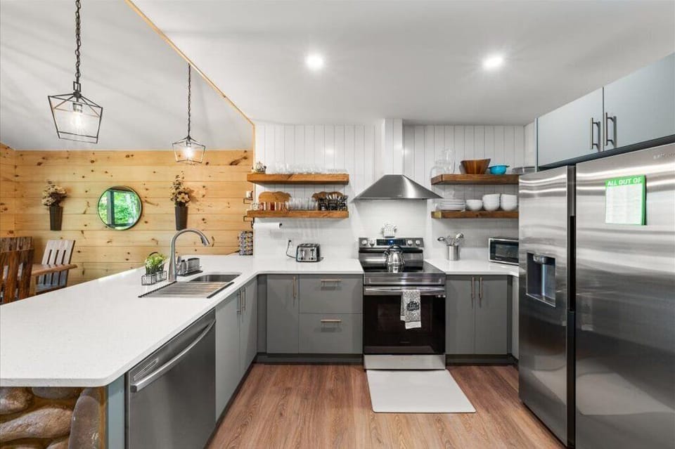 Open shelves with plates, glasses, and utensils available at reach 