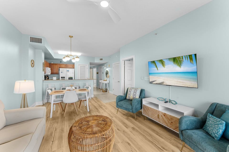 Bright living room with Gulf views, a smart TV, and a queen pull-out sofa—perfect for relaxing after beach days.