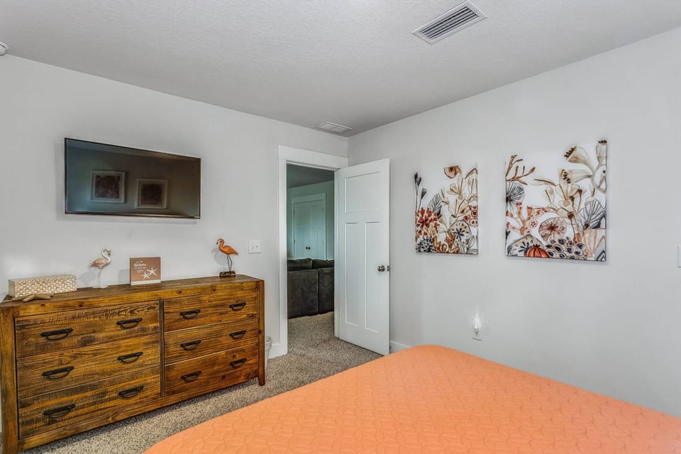 This guest bedroom also has a flat screen tv.