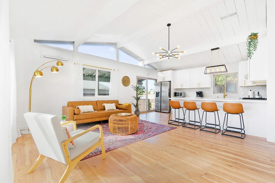 Enjoy the airy open-concept layout with soaring ceilings, comfortable seating, and a fully equipped kitchen.