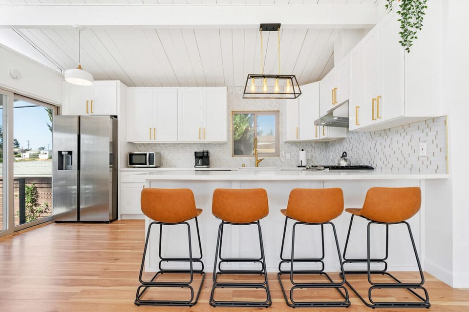 ### Photo 1 – Patio at Sunset  **Airbnb Caption:** Enjoy relaxing evenings on the private patio with string lights, outdoor dining, and beautiful sunset skies.  **Vrbo Caption:** Private outdoor patio featuring dining space, ambient lighting, and a cozy s
