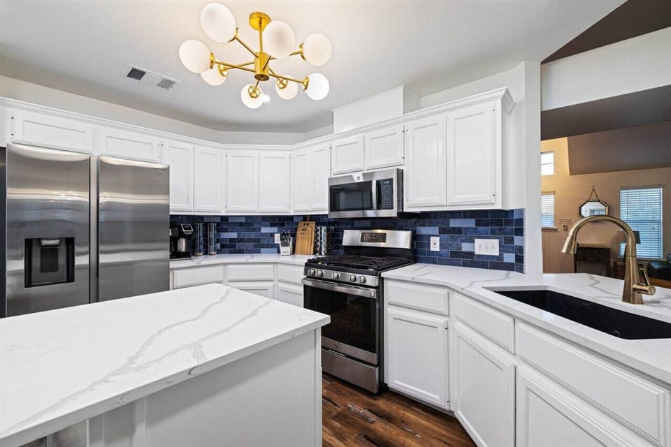 Large refrigerator, gas stove, microwave, Keurig coffee maker, stone design countertops.