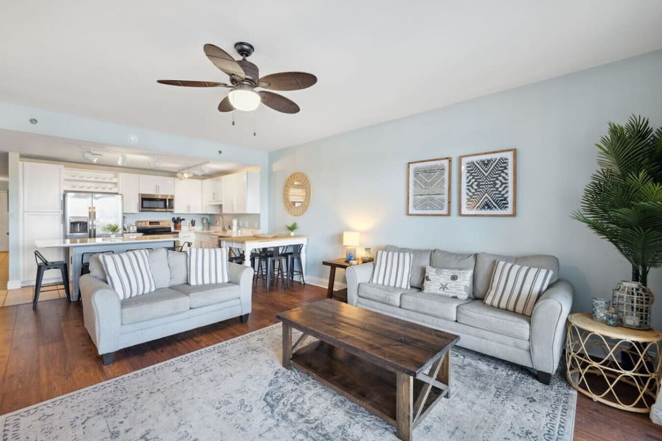 Living Area with Lake and Light Show Views, Flat Screen TV, Sleeper Sofa and Private Balcony Access