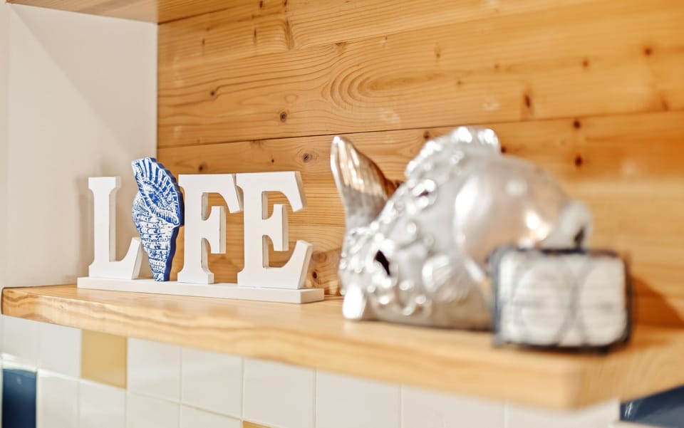 Kitchen Detail — LIFE Sign with Seashell Accent & Silver Fish Sculpture