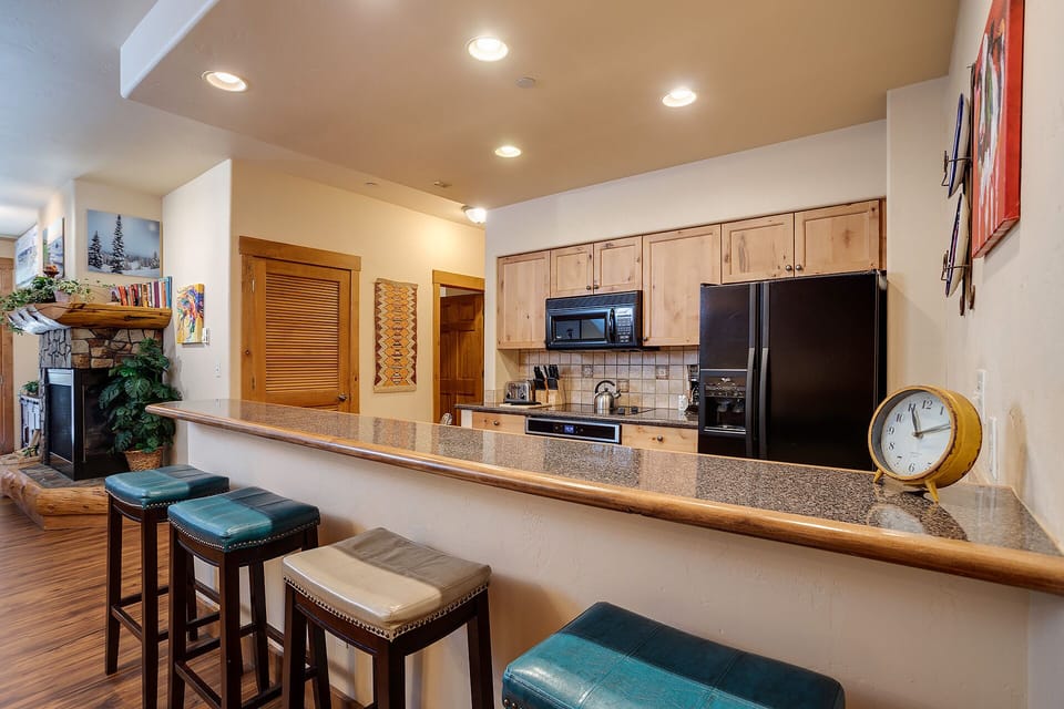 Gather around this beautiful breakfast bar where your morning coffee and evening conversations come alive in this thoughtfully designed kitchen space.