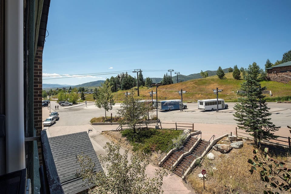 Mountain town view from your window showcases rolling hills, evergreen forests, and peaceful community surroundings.