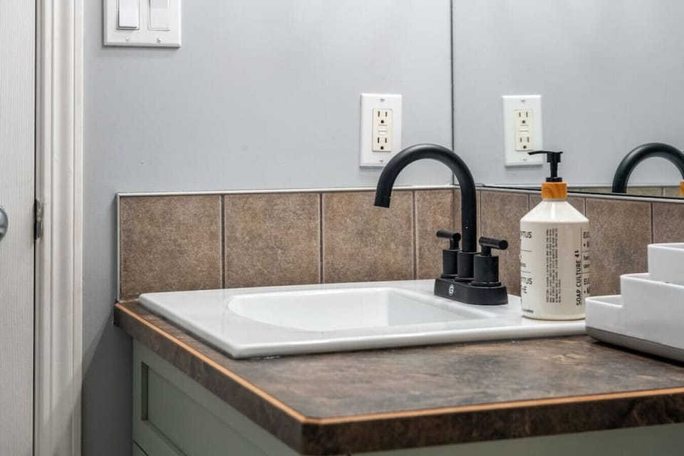 First full bathroom, located on the main floor, with a shower/tub combo. Each bathroom comes stocked with towels, a hair dryer, shampoo, conditioner & body wash.