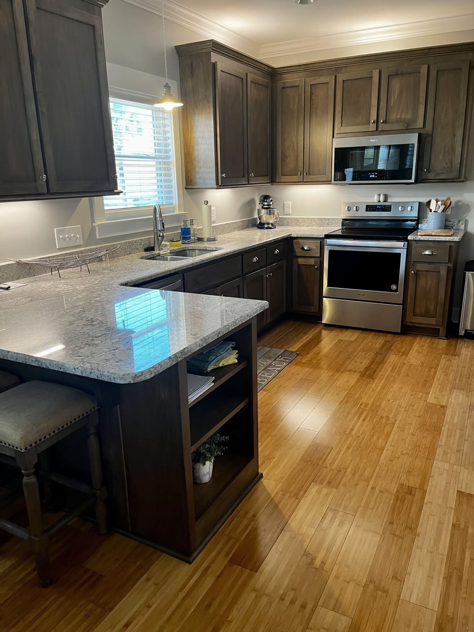 Well stocked kitchen with barstools 