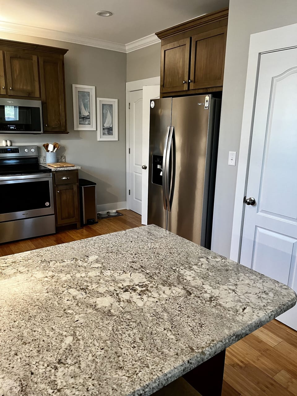 Pantry and laundry area beside the refrigerator 