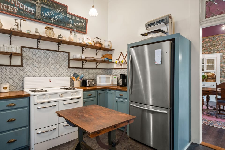 Kitchen with Wedgewood gas stove, microwave, toaster and coffee maker.
