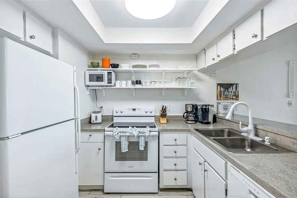 A bright and fully equipped kitchen, ready for preparing delicious home-cooked meals.
