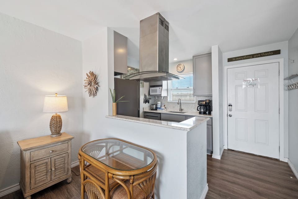 Your open-concept space blends living and cooking areas seamlessly, with modern appliances and warm coastal touches creating the perfect retreat.
