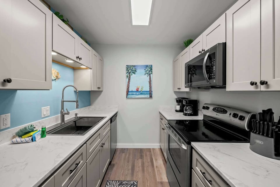 We've stocked this kitchen with full appliances, dishes, bake ware, pots & pans, silverware, utensils, crockpot, blender, and a traditional coffee maker & Keurig!