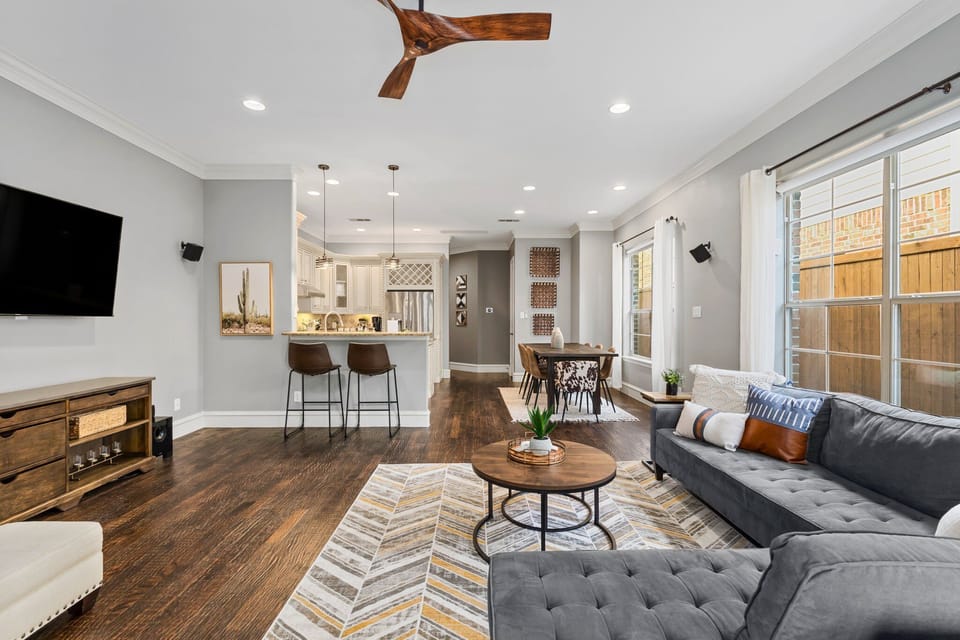 This great open concept living room is perfect for entertaining with plenty of seating, counter space, fireplace, and a 65" SmartTV.