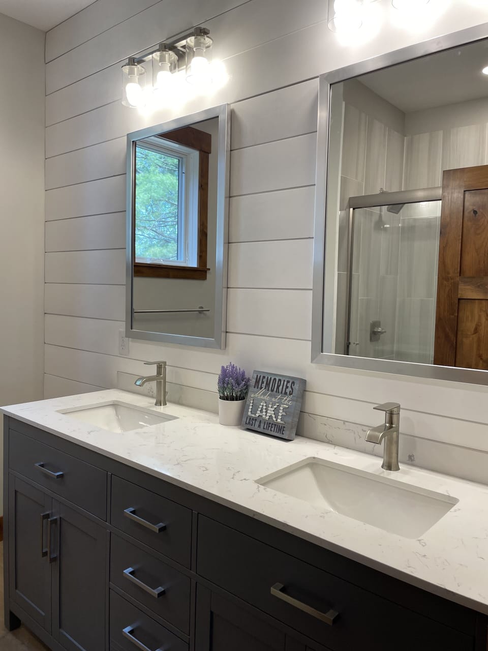 Main level bathroom double vanity with shiplap accent wall.