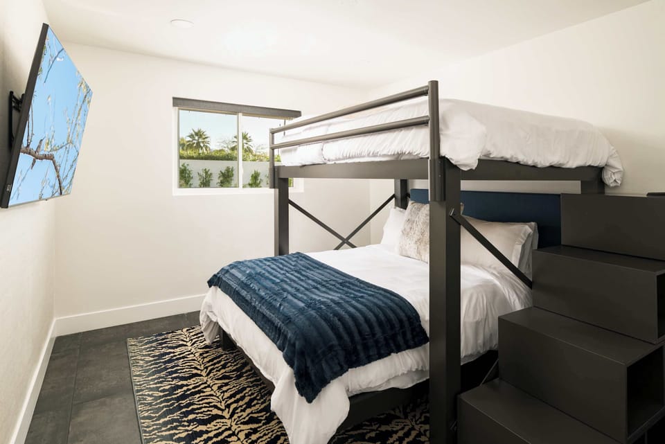 Four guests can comfortably sleep on this modern queen over queen bunk bed.