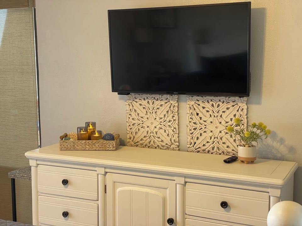 47 inch tv with Roku player in primary bedroom