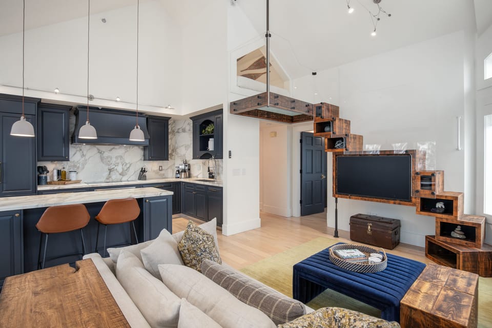 Kitchen and living area - modern, fully stocked kitchen, with large TV and additional loft sleeping space