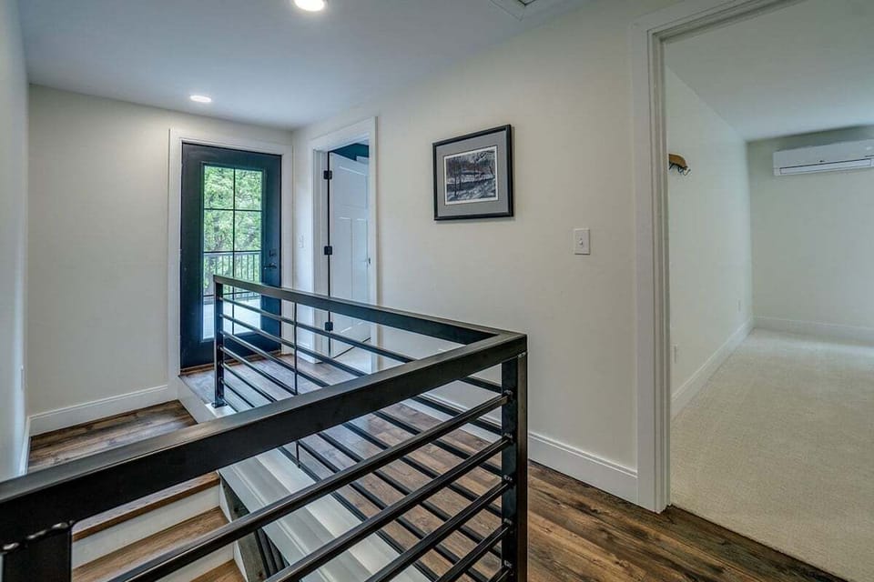 Upstairs hallway with door to the second floor deck