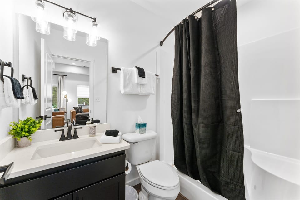 Main floor bathroom offering a versatile shower for quick refreshes or longer routines.
