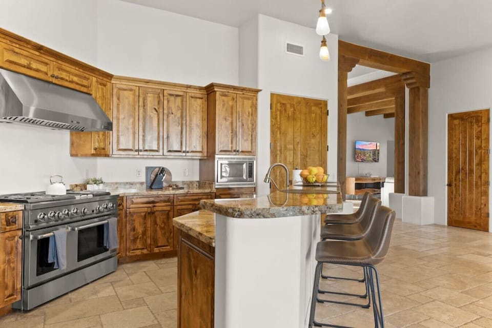 Kitchen featuring an island with bar seating, stainless steal appliances