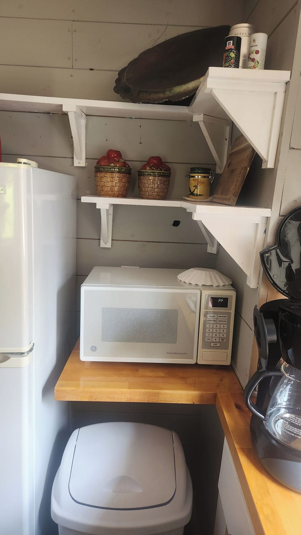 Microwave, apartment fridge and extra storage in the kitchen