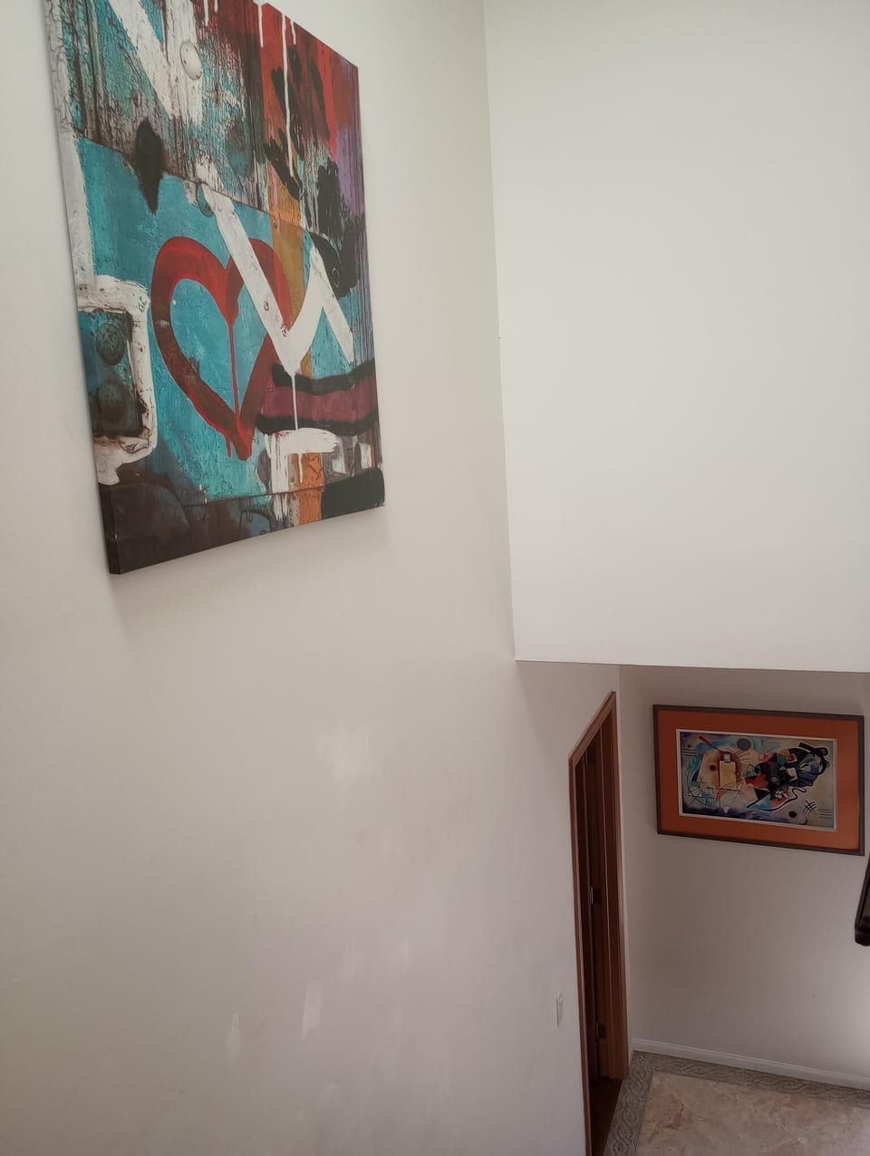 Bright stairway due to two skylights looking down with two entryway.
