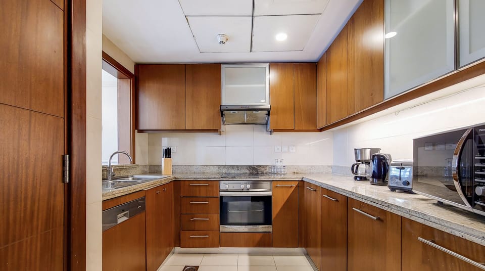 Luxury Apartment | Private kitchen | Fridge, microwave, cleaning supplies, paper towels