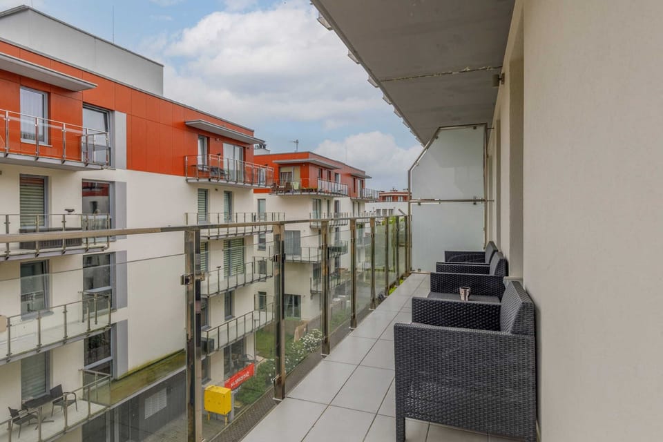 A spacious balcony with outdoor seating, ideal for enjoying fresh air and relaxation.