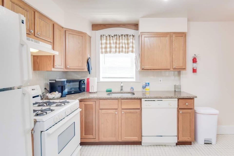 The kitchen is fully stocked with pots and pans and plenty of dishes, glasses and coffee mugs.