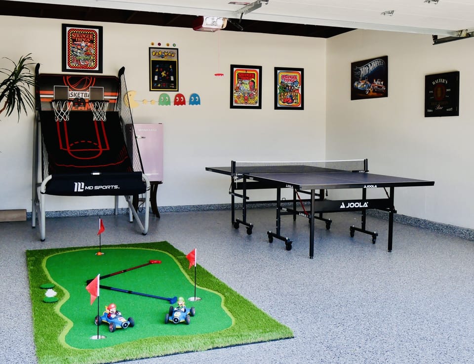 Private 2 car garage w/ 🏓 table, darts 10’x5’ putting green, Mario &Luigi rc car