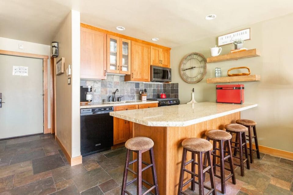 Small but mighty kitchen has everything you could want with lots of seating! Refrigerator and freezer drawers in cabinets.