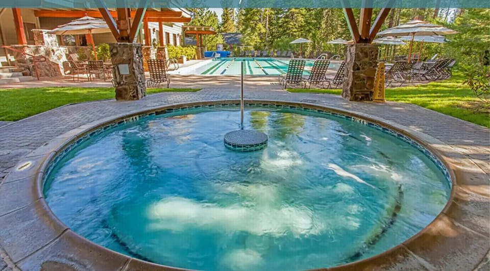 One of the 3 year-round hot-tubs with heated lap pool in background.