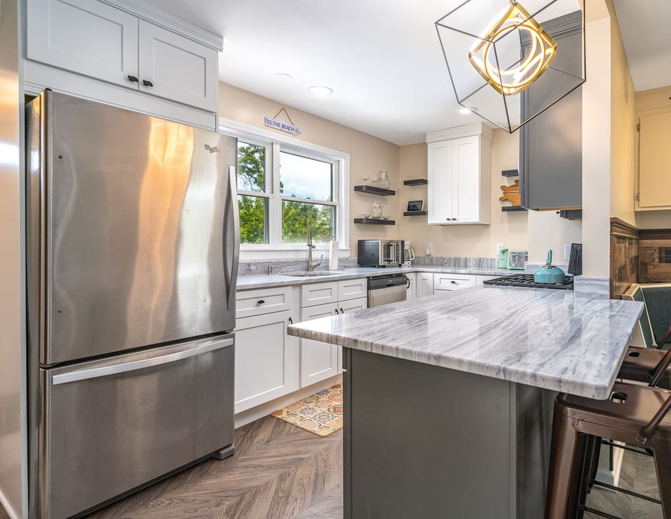 View of our newly renovated kitchen! Microwave, oven, dishwasher, refrigerator.