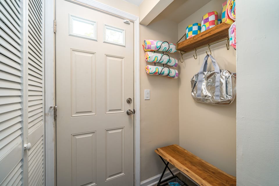 Back door to the deck / pool. Sitting area for shoes. Beach towels!