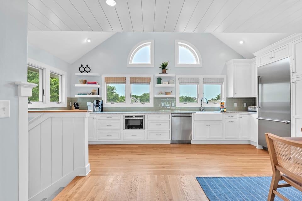 A fully stocked gourmet kitchen with loads of windows