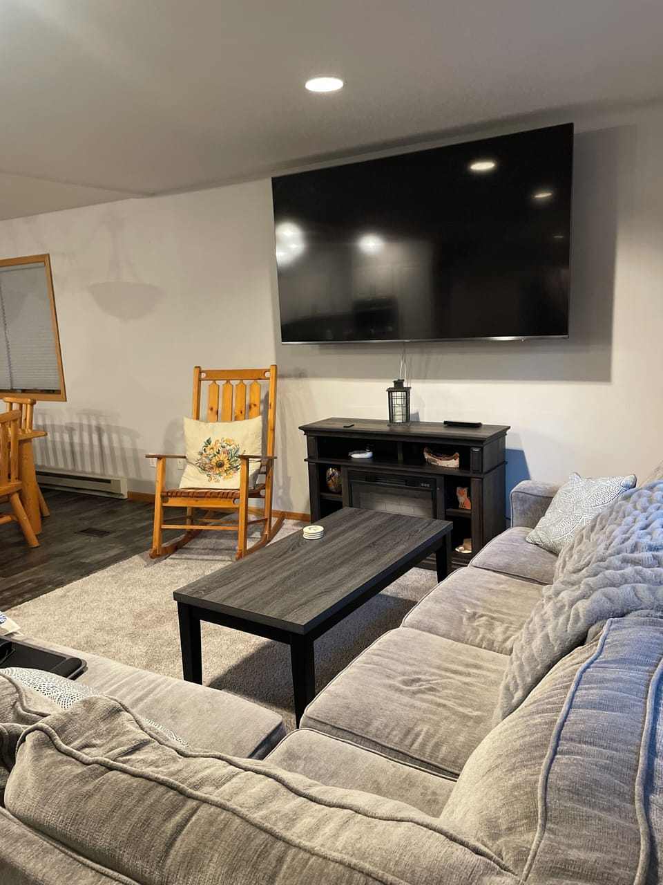 Living room on main floor with 90” tv.