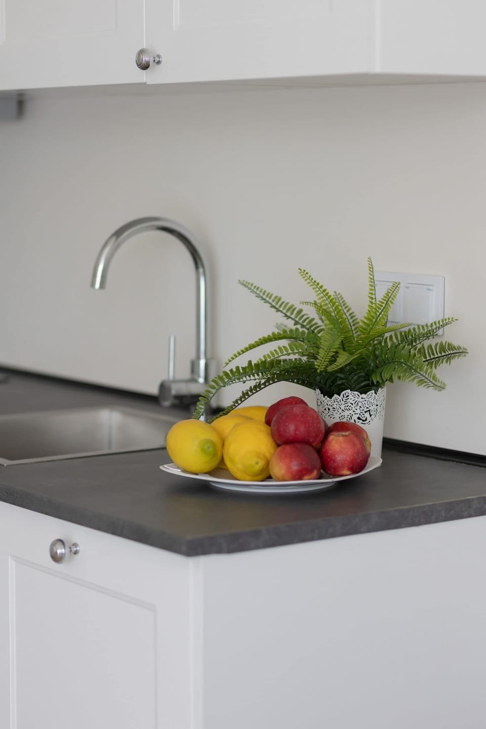 The sleek design of the kitchenette blending seamlessly with the living area.
