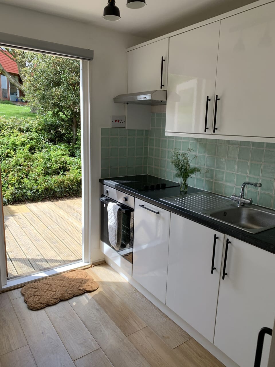 Full kitchen with dishwasher, microwave and access to back deck