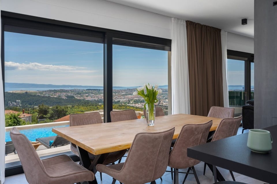 a fully equipped kitchen with all the amenities you need,   a kitchen island and a dining table 