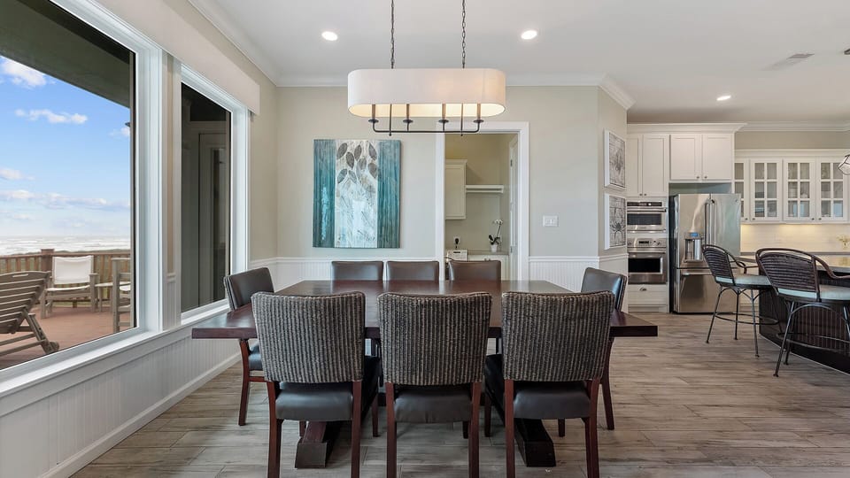 Dining Room: Comfortably seats 8 with scenic beach views.