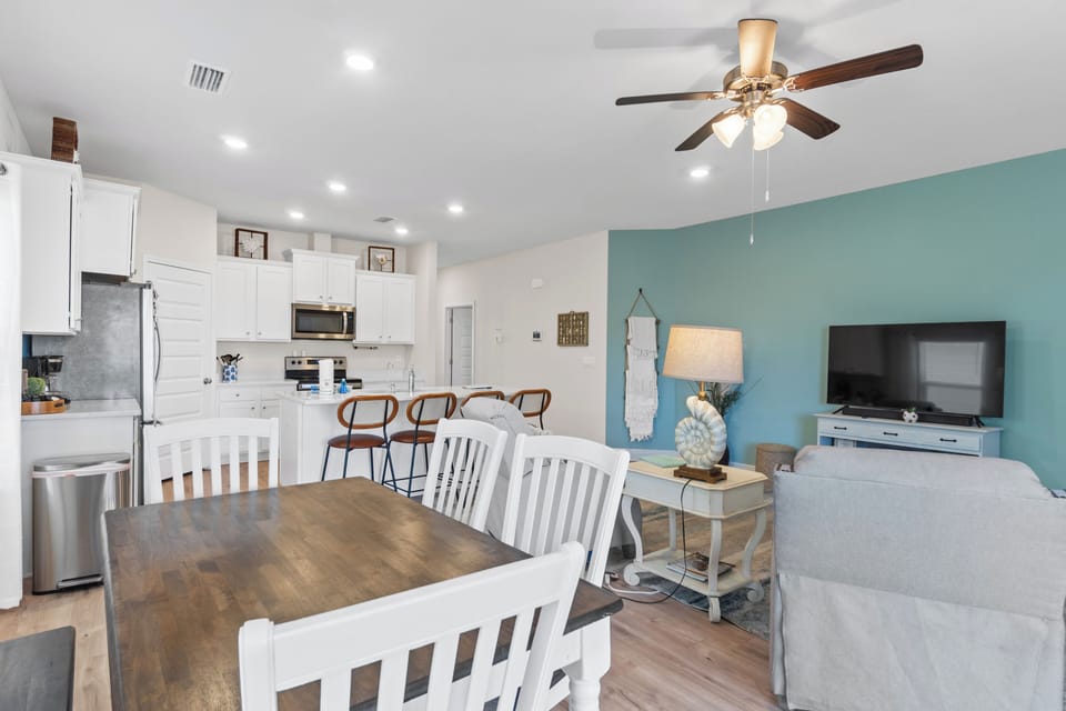 Your spacious open-plan living area seamlessly blends kitchen, dining, and relaxation zones with coastal charm and modern comfort.