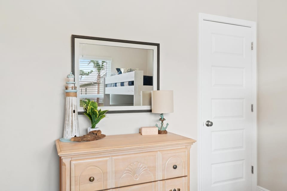 Your dresser offers plenty of storage with charming coastal touches and a peaceful view through the window.