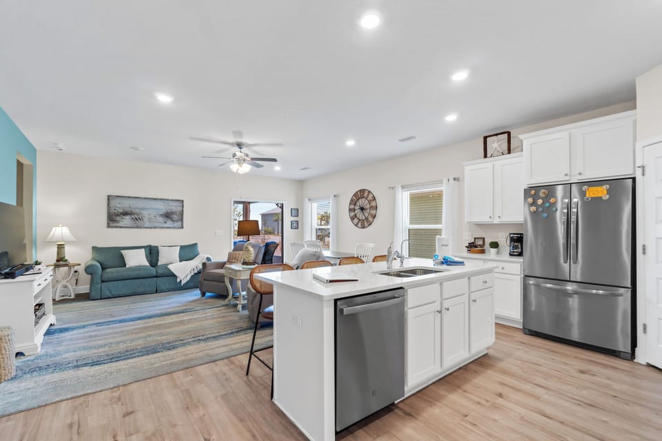 Relax in your bright open-plan living space where the fully equipped kitchen flows seamlessly into your cozy lounge area.
