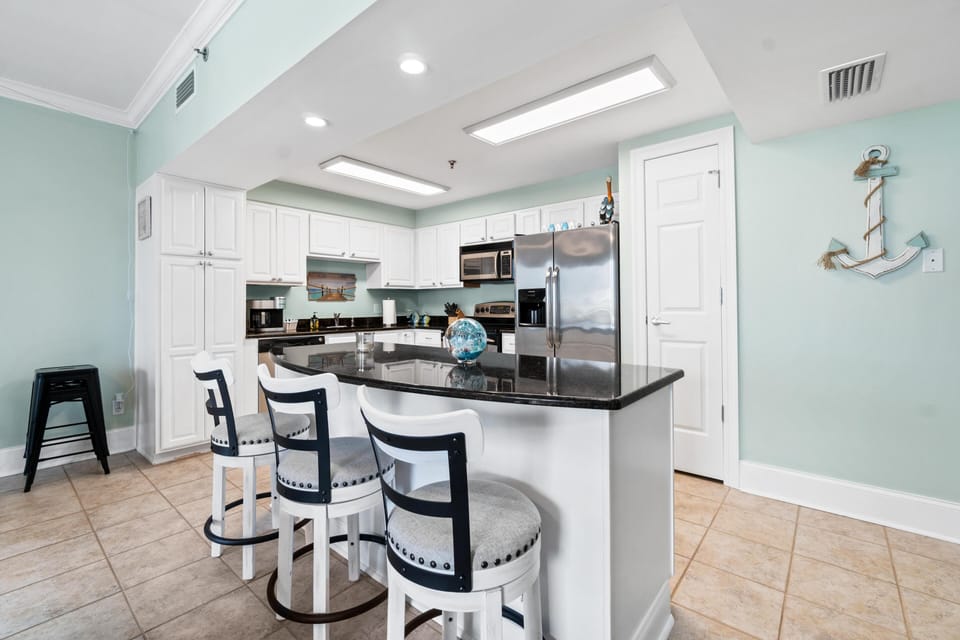 Your fully equipped kitchen features granite countertops, stainless steel appliances, and a breakfast bar where you can enjoy morning coffee together.