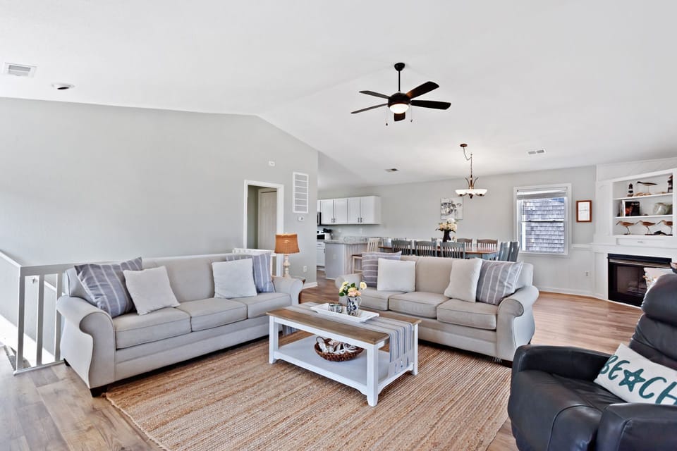 The Top Level is the home's premiere spot with a large, open Living Area that boasts vaulted ceilings and vinyl plank flooring.