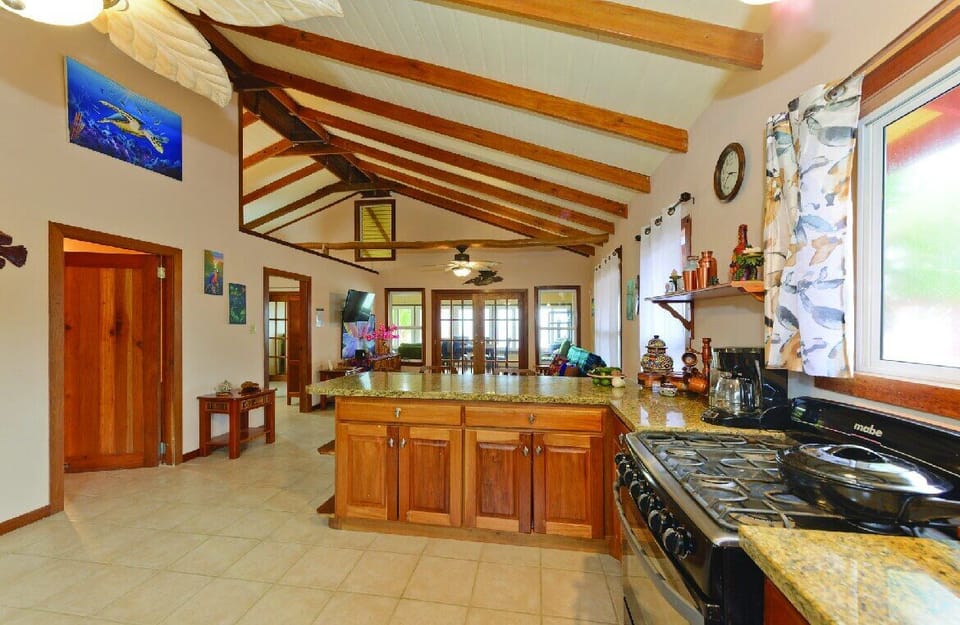 Open concept kitchen with barstool dining. Garden and ocean views.